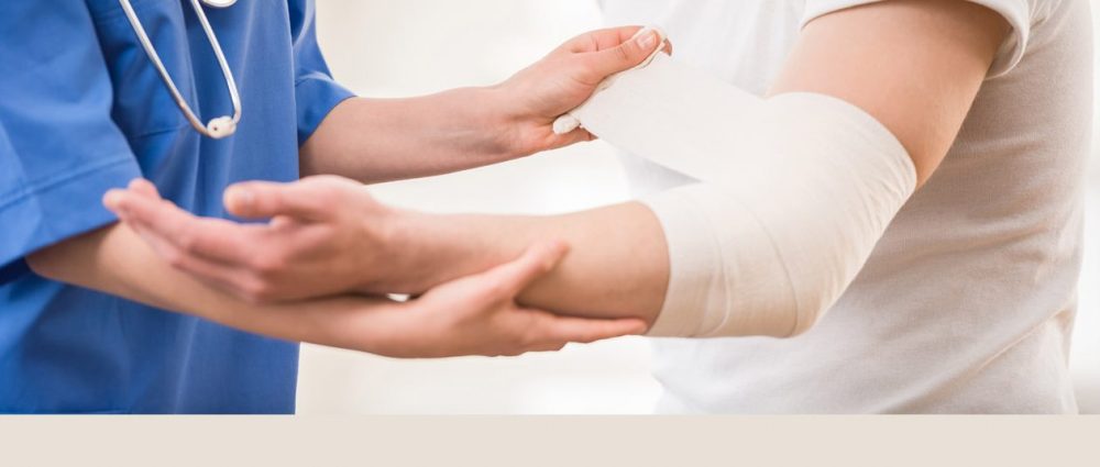 Orthopedic surgeon wrapping elbow
