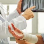 Orthopeadic surgeon explaining hand injury to patient